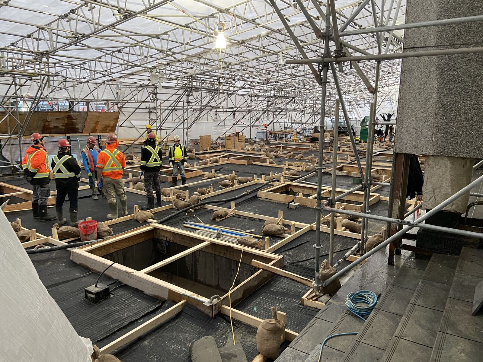 Crew working on the roof deck of a large-format building