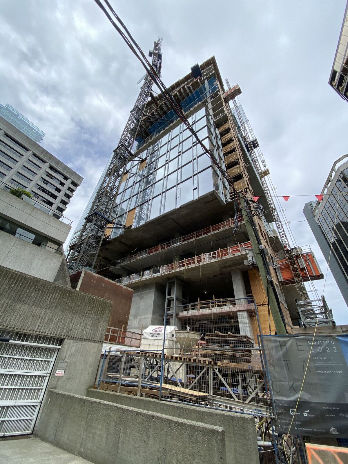 Tower crane over a high-rise concrete structure under construction